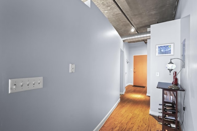 hall with wood finished floors and baseboards