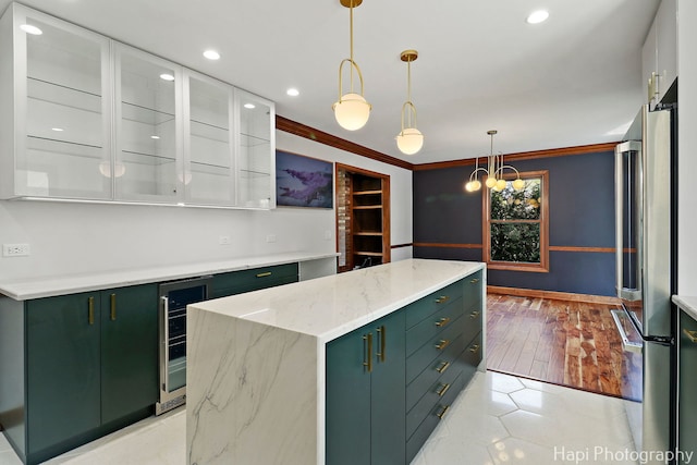 kitchen featuring a kitchen island, white cabinets, green cabinets, freestanding refrigerator, and recessed lighting