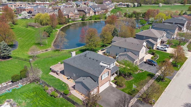 birds eye view of property featuring a water view and a residential view