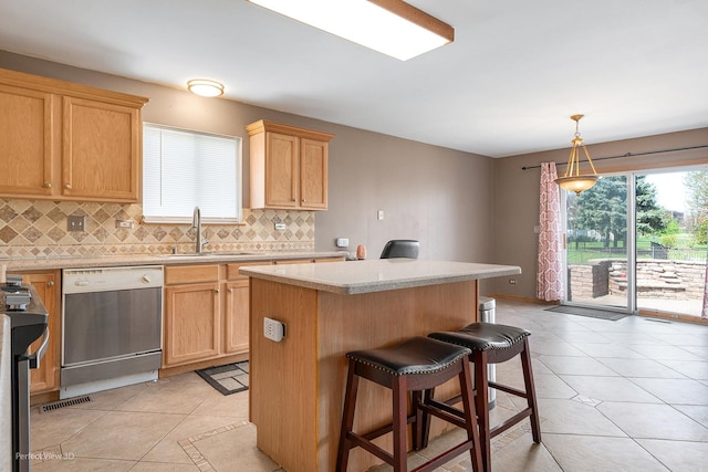 kitchen featuring a sink, dishwashing machine, light tile patterned flooring, and decorative backsplash