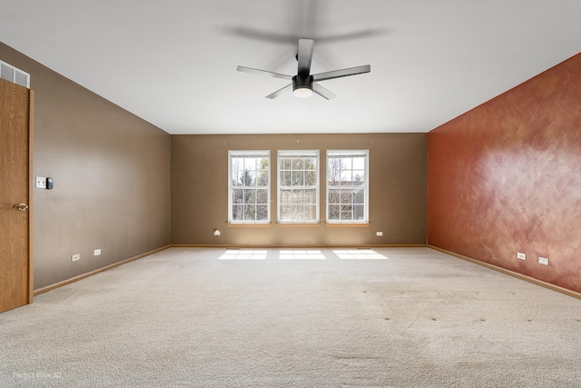 spare room featuring baseboards, ceiling fan, carpet flooring, and visible vents