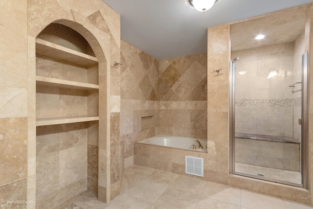 full bathroom featuring visible vents, a garden tub, a shower stall, and tile walls