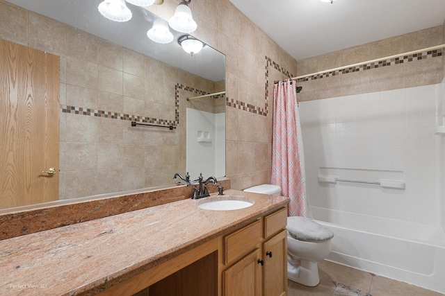 bathroom featuring vanity, toilet, tile patterned floors, shower / bath combination with curtain, and tile walls