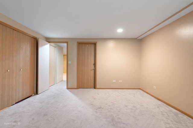 unfurnished bedroom featuring recessed lighting, baseboards, and light carpet