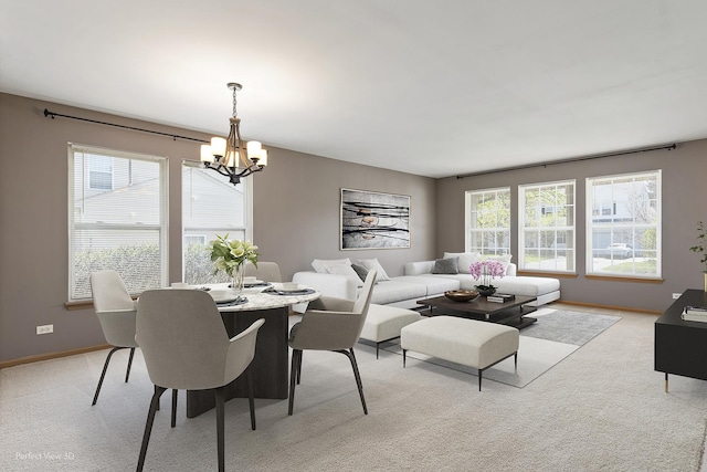 dining space featuring baseboards, light colored carpet, and a notable chandelier