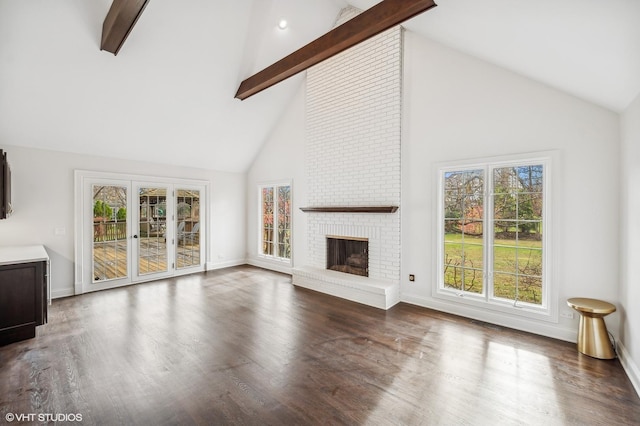 unfurnished living room featuring high vaulted ceiling, beam ceiling, and wood finished floors