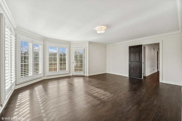 unfurnished room with dark wood-style flooring, baseboards, and ornamental molding