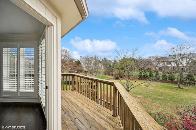wooden deck featuring a lawn