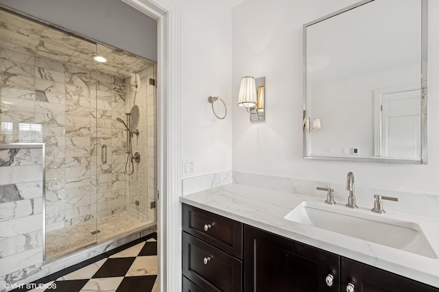 full bath with vanity, tile patterned floors, and a stall shower