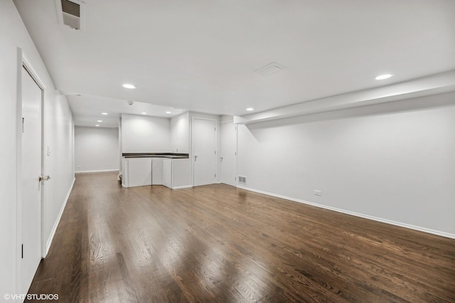 basement featuring baseboards, recessed lighting, wood finished floors, and visible vents