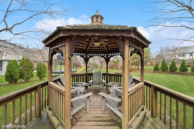 wooden terrace with a gazebo and a yard