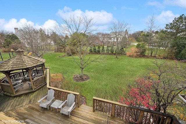 wooden deck featuring a gazebo and a yard