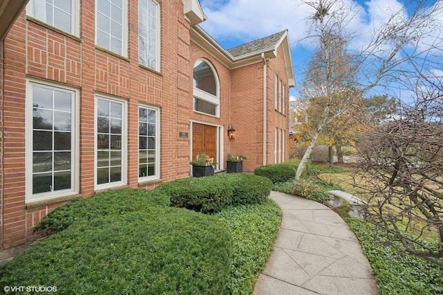 view of side of property featuring brick siding