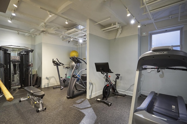 222 E Chestnut St Unit 7B, Chicago, IL 60611 - gym featuring baseboards, rail lighting, and ceiling fan