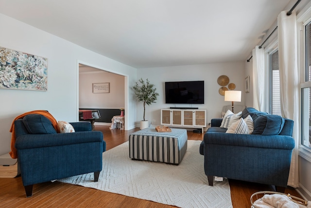living room featuring baseboards and wood finished floors