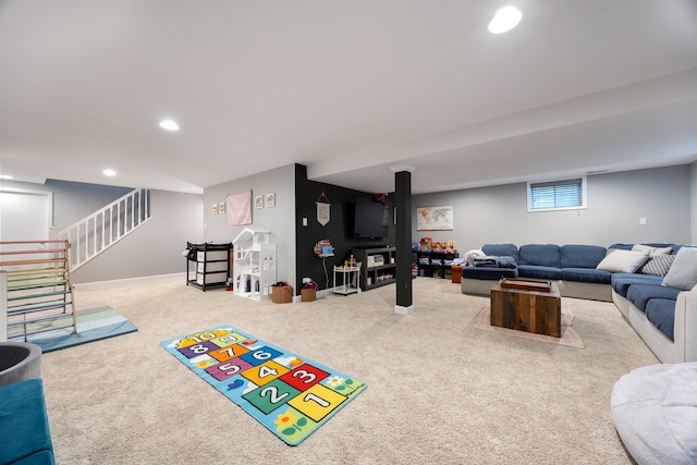 carpeted living area featuring recessed lighting and stairway