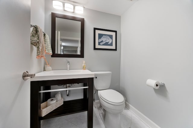 half bath featuring toilet, baseboards, marble finish floor, and vanity