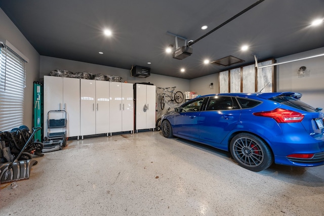garage featuring recessed lighting and a garage door opener