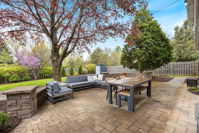 view of patio / terrace with outdoor dining area, a fenced backyard, and an outdoor hangout area