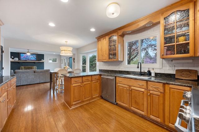 kitchen featuring a sink, brown cabinets, and dishwasher