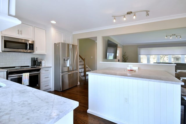 kitchen with backsplash, dark wood-style flooring, crown molding, white cabinets, and stainless steel appliances