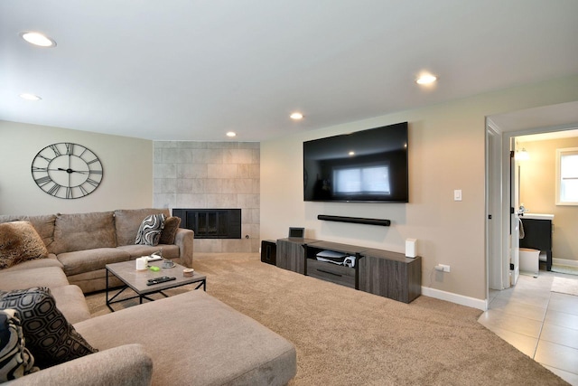 tiled living area with carpet flooring, recessed lighting, baseboards, and a fireplace
