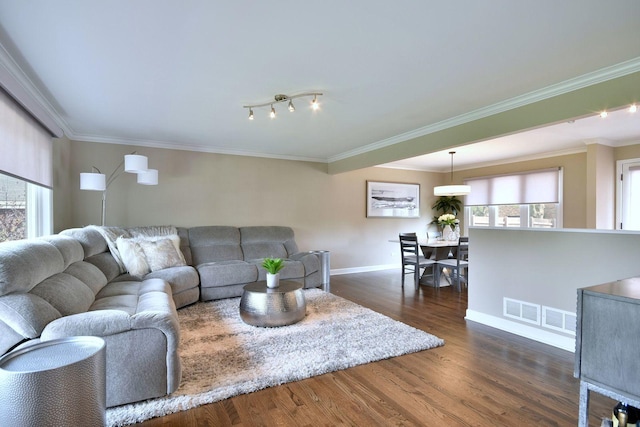 living room with dark wood-style flooring, baseboards, and ornamental molding