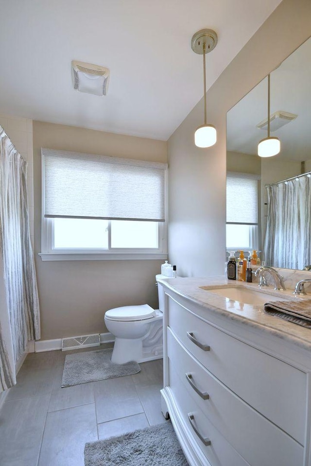 bathroom featuring visible vents, tile patterned floors, toilet, and vanity