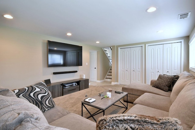 living area with visible vents, recessed lighting, and stairs