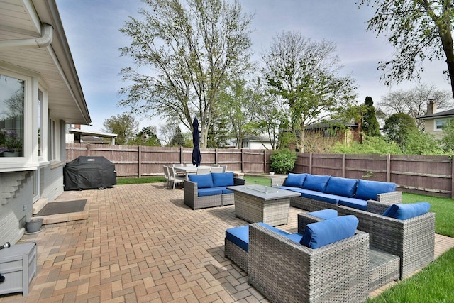 view of patio / terrace featuring a fenced backyard, outdoor lounge area, and a grill