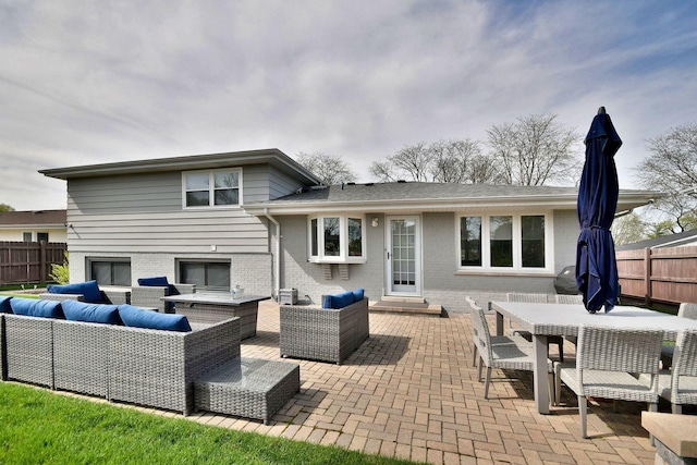 rear view of house with brick siding, an outdoor hangout area, and a patio area