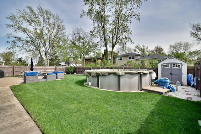view of yard featuring a deck, a fenced backyard, a shed, an outdoor hangout area, and a fenced in pool
