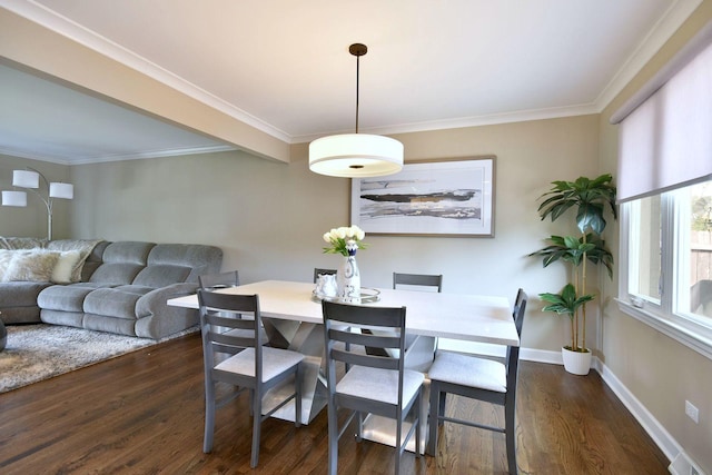 dining room featuring crown molding, baseboards, and dark wood-style floors