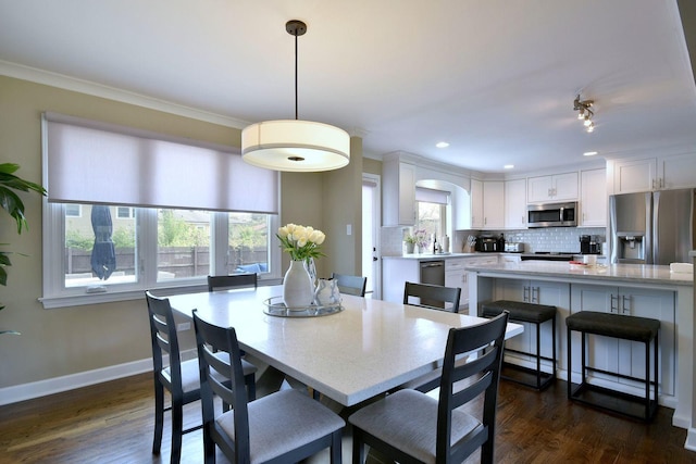 dining area with recessed lighting, baseboards, dark wood finished floors, and ornamental molding