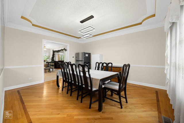 401 Jason Ln, Schaumburg, IL 60173 - dining room with a textured ceiling, visible vents, ornamental molding, and light wood-type flooring