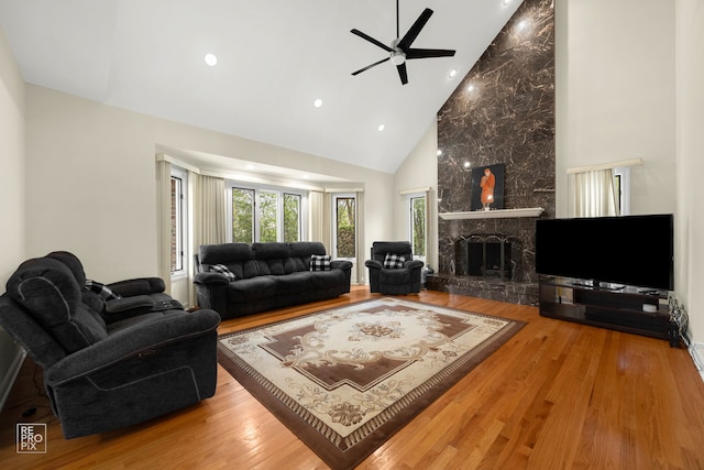 401 Jason Ln, Schaumburg, IL 60173 - living area with high vaulted ceiling, ceiling fan, a large fireplace, and wood finished floors