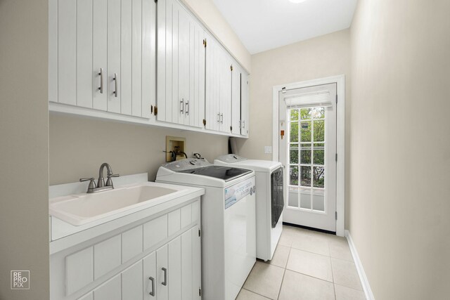 401 Jason Ln, Schaumburg, IL 60173 - clothes washing area with cabinet space, independent washer and dryer, light tile patterned flooring, a sink, and baseboards
