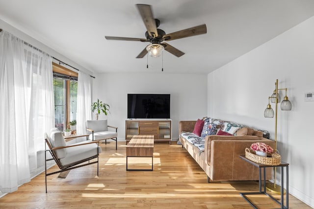 living room with ceiling fan and light wood-style flooring
