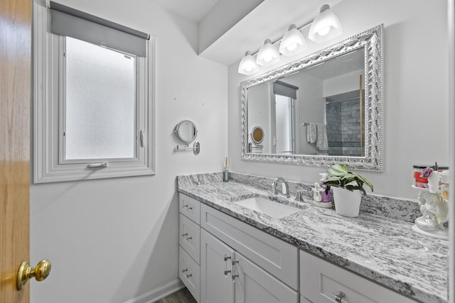 bathroom featuring vanity and a shower