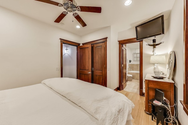 bedroom featuring recessed lighting, ceiling fan, ensuite bathroom, and light wood-style floors