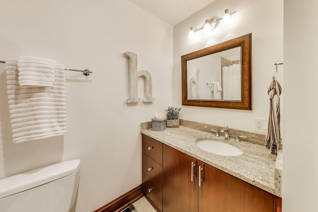 bathroom with vanity and toilet