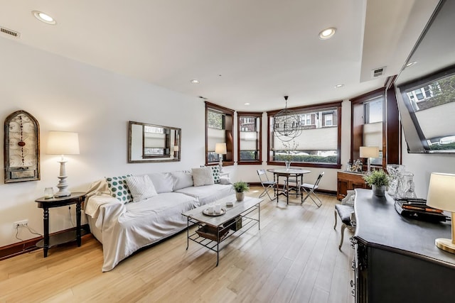 living area with light wood-style floors, recessed lighting, and visible vents