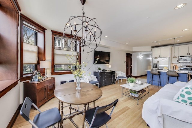 living area featuring recessed lighting, a notable chandelier, and light wood-type flooring