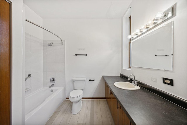 full bathroom with vanity, wood finished floors, bathing tub / shower combination, toilet, and baseboards