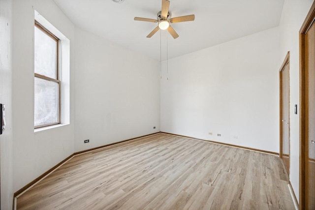 unfurnished bedroom featuring light wood-style floors, baseboards, and a ceiling fan