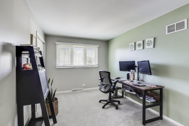 office featuring carpet flooring, baseboards, and visible vents