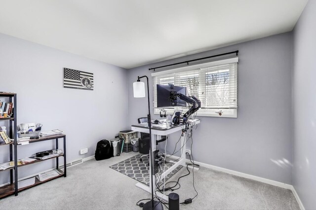 workout room featuring baseboards and carpet flooring