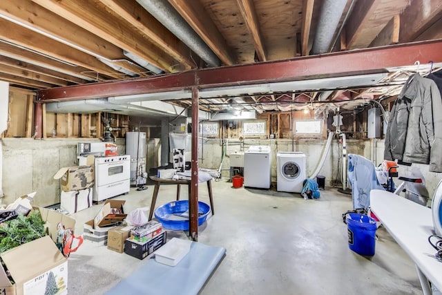 below grade area with a sink, gas water heater, and washer and dryer