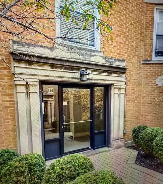 property entrance featuring brick siding