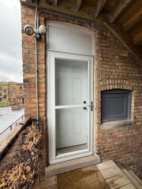 534 W Belmont Ave Unit 2S, Chicago, IL 60657 - property entrance featuring brick siding